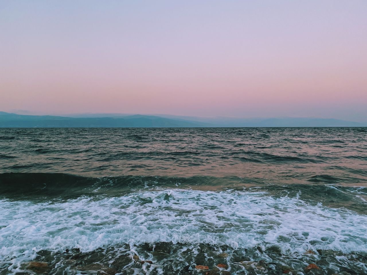 Capture the calmness of the sea at twilight with a pink horizon in Bursa, Türkiye.