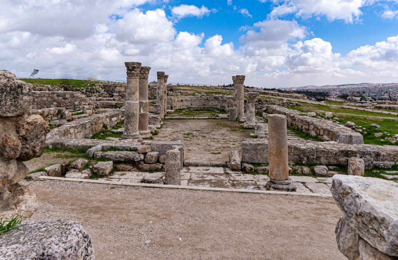 Explore the historic ruins of ancient Roman structures in Amman, Jordan, under a picturesque sky.